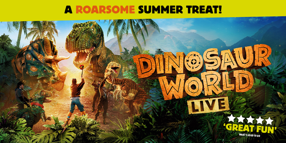 A vibrant dinosaur puppet interacts with children in a lively outdoor setting, surrounded by greenery and colourful decorations.
