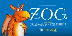 A vibrant illustration of Zog, a dragon, flying over a colourful landscape with hills and trees.