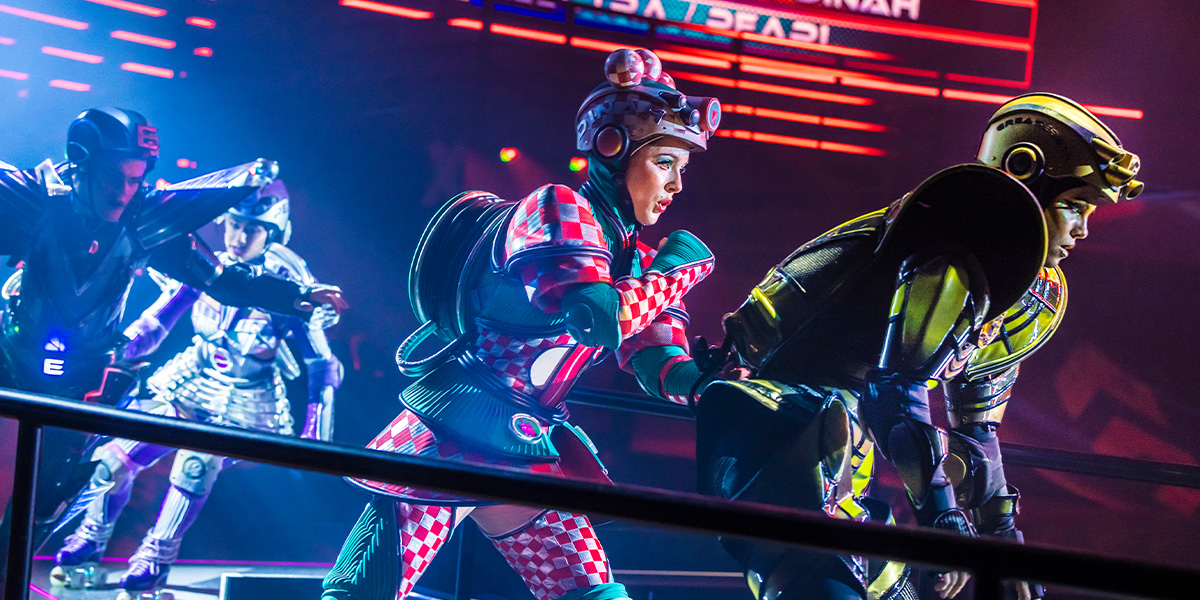 A vibrant scene from Starlight Express featuring performers in colourful costumes on roller skates, dynamic poses.
