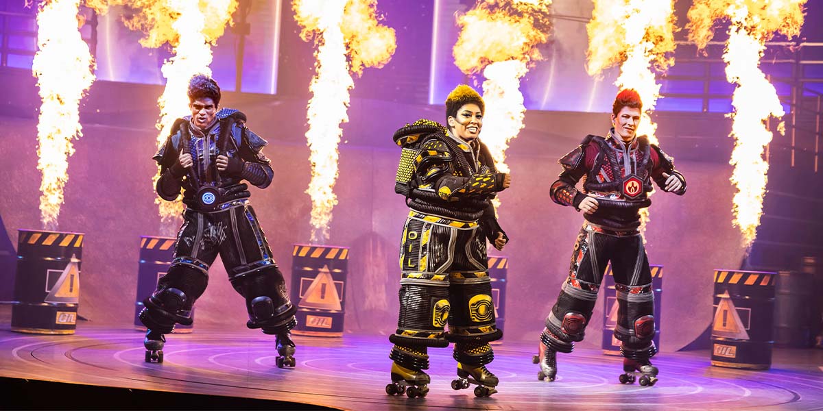 A vibrant scene from Starlight Express featuring colourful costumes and dynamic poses of performers on stage.