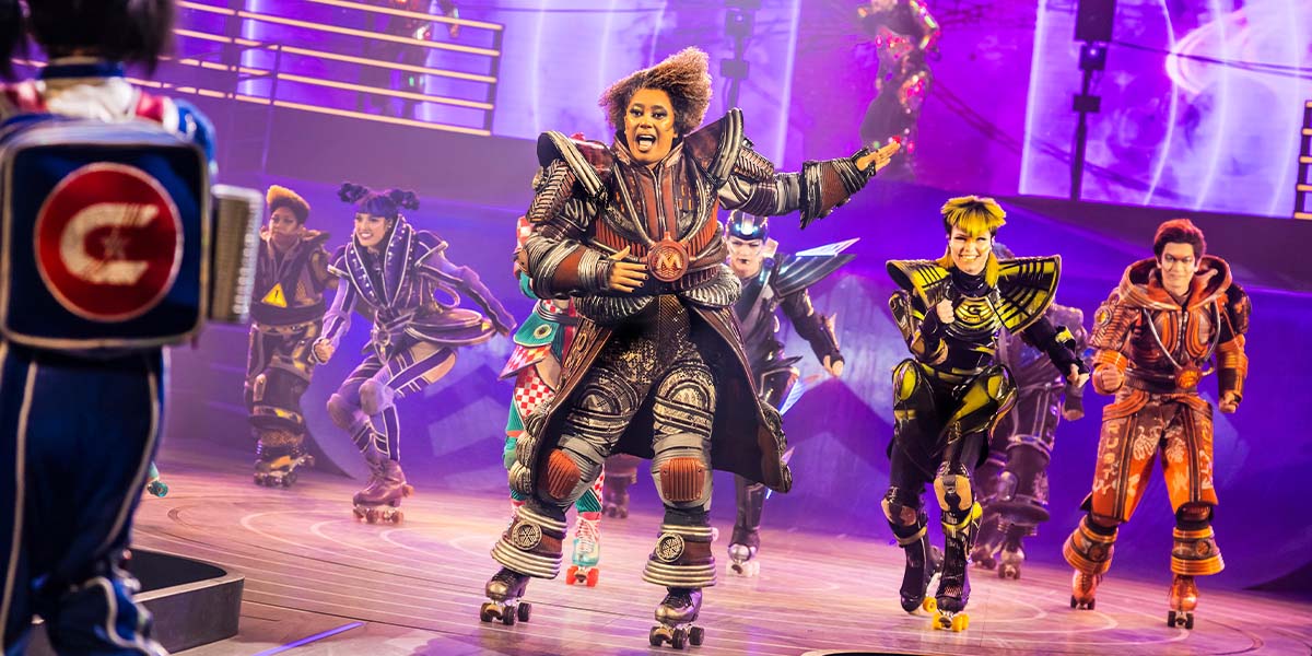 A vibrant scene from Starlight Express featuring performers in colourful costumes on a dynamic stage.