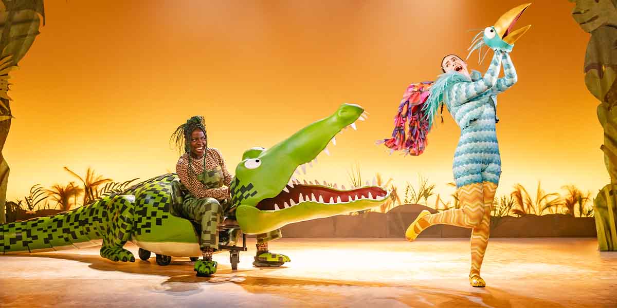 Chelsea Da Silva as The Enormous Crocodile laughs while Ciara Hudson as Roly Poly Bird dances joyfully.