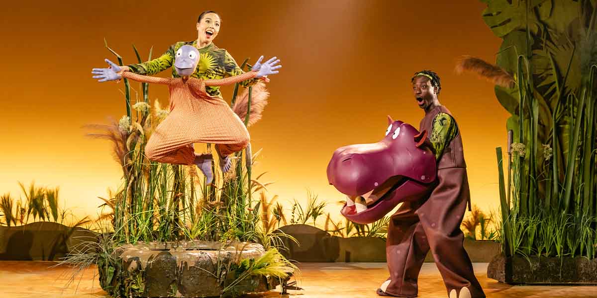 Marienella Phillips as Muggle Wump and Jordan Eskeisa as Humpy Rumpy perform on stage, surrounded by greenery.