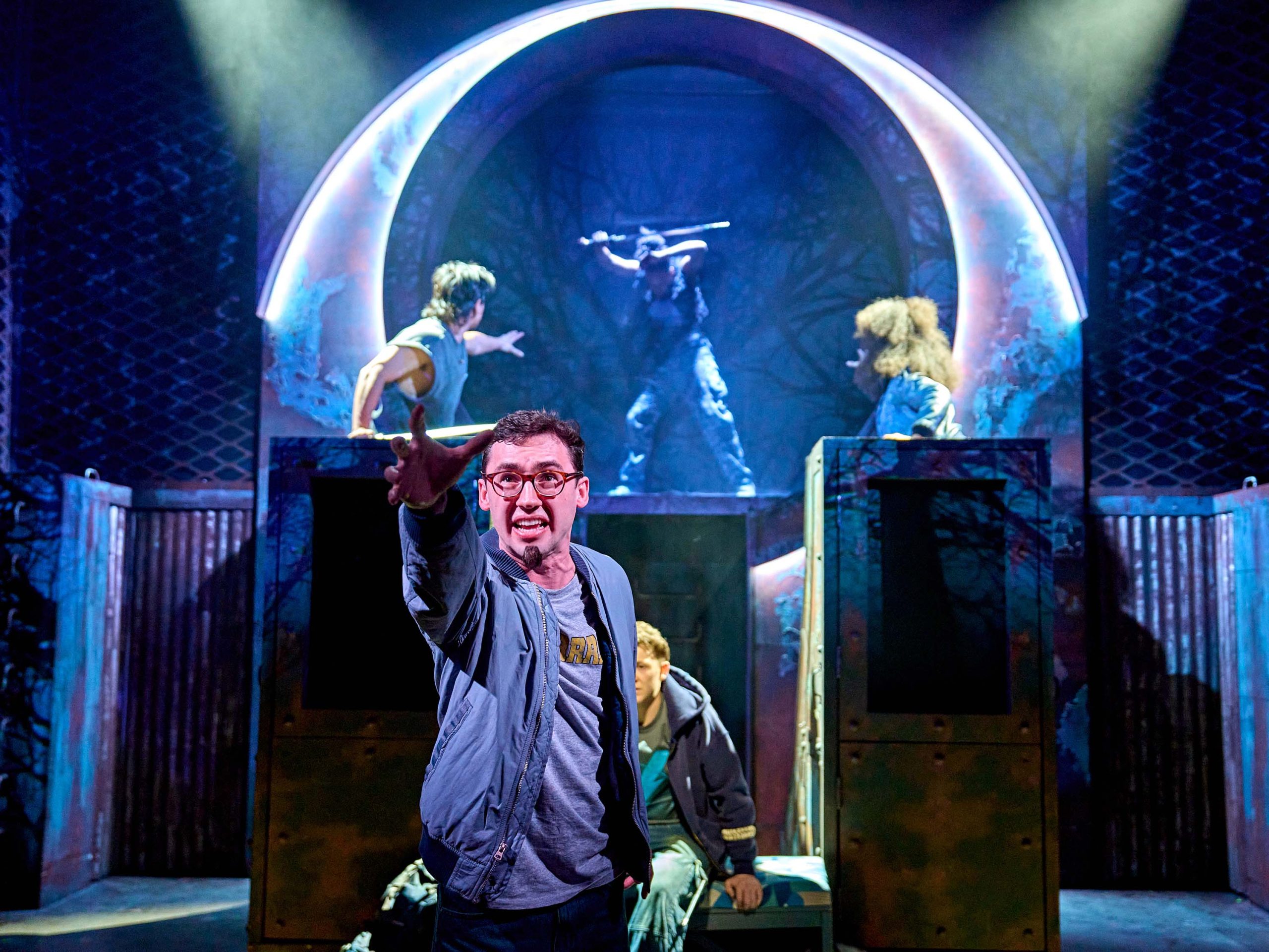 A character is standing on stage with their right are out in front of them as if they are reaching for something. The character looks distressed.