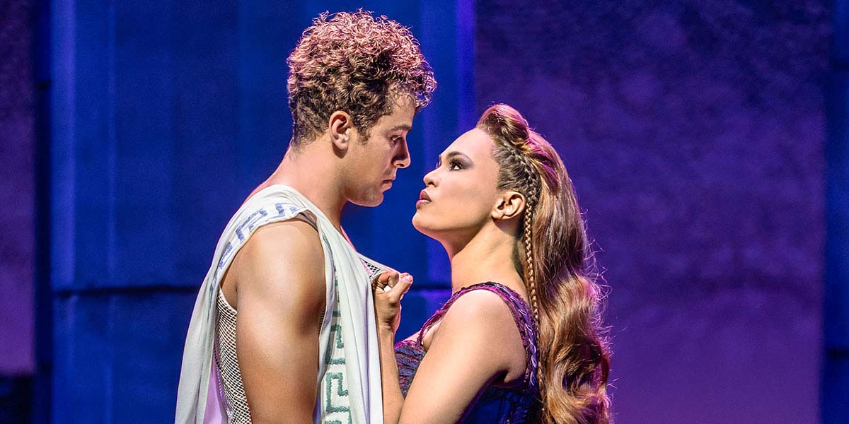 Hercules, portrayed by Luke Brady, and Meg, played by Mae Ann Jorolan, pose together in vibrant costumes.