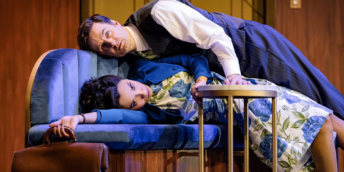 Two people lay on a sofa.