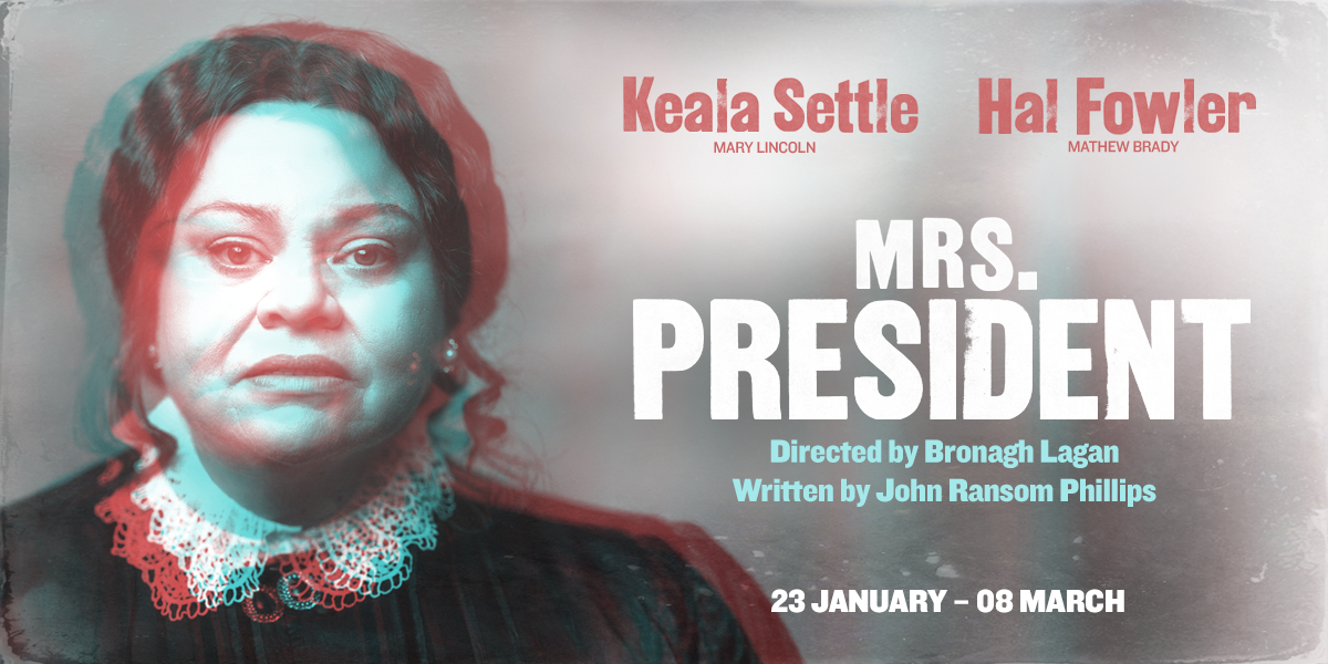 Mrs President stands confidently, wearing a tailored suit, against a neutral background, smiling warmly at the camera.