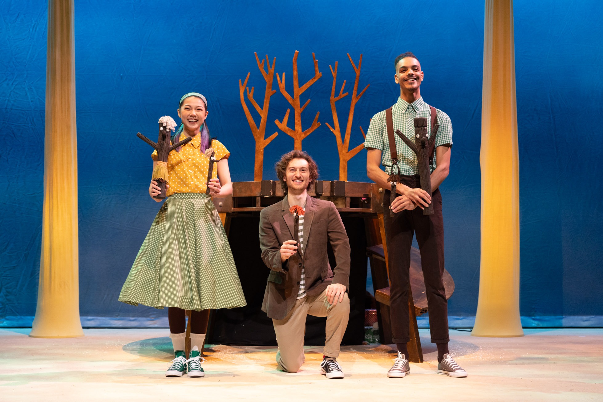 A stick figure character stands on a textured surface, with a bright blue background and simple facial features.