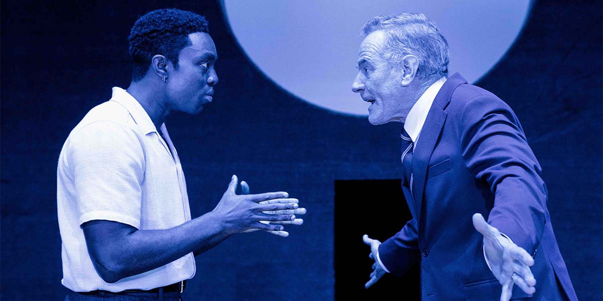 Paapa Essiedu as Chris Keller and Bryan Cranston as Joe Keller in a dramatic scene from All My Sons.