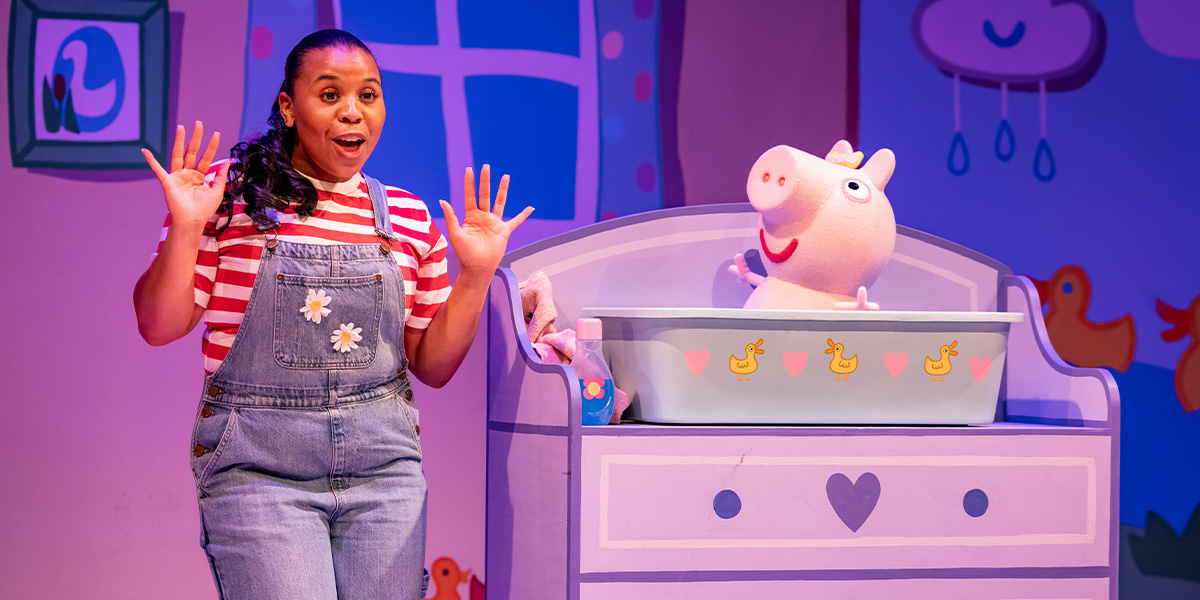 Daisy and Evie play with bubbles, surrounded by colourful decorations from Peppa Pig's Big Family Show.