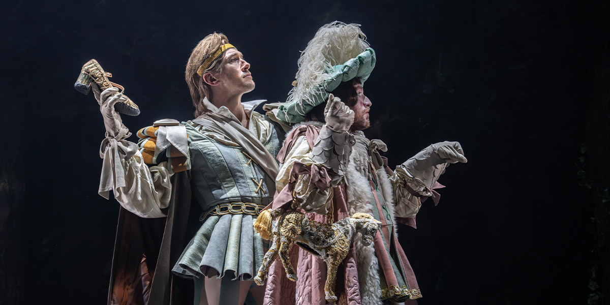 A prince in regal attire stands with one arm raised in front of them.