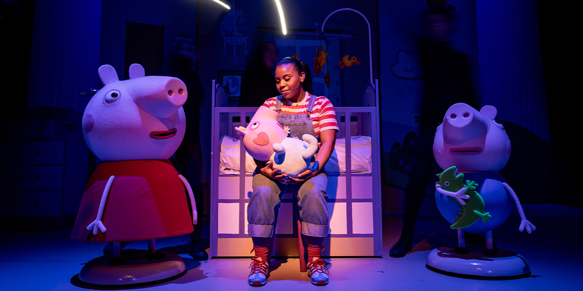 Peppa Pig, Evie, Daisy, and George are smiling together on stage during Peppa Pig's Big Family Show.