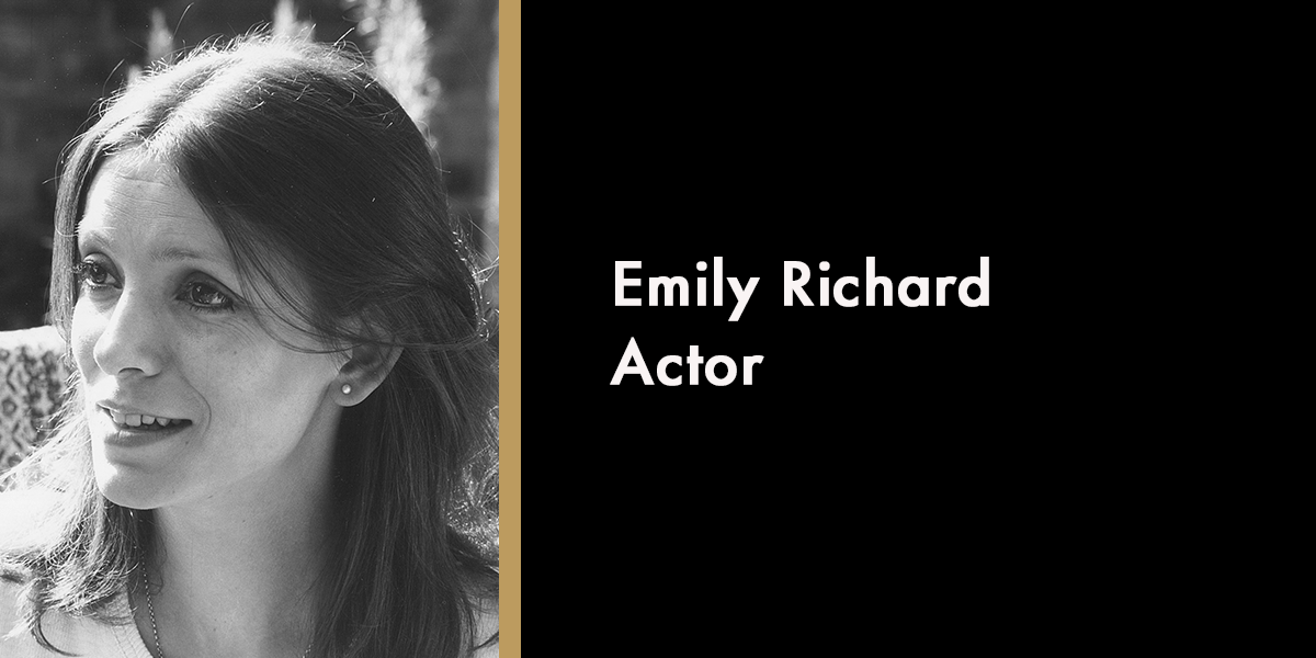 Emily Richard with long hair, smiling, wearing a light-coloured top, outdoors.