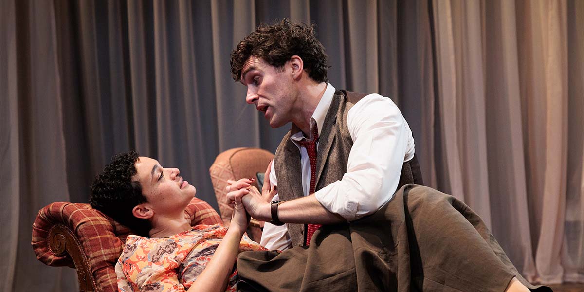 Lily Nichol and Ewan Miller perform in "The Rat Trap," surrounded by a textured, dimly lit stage.