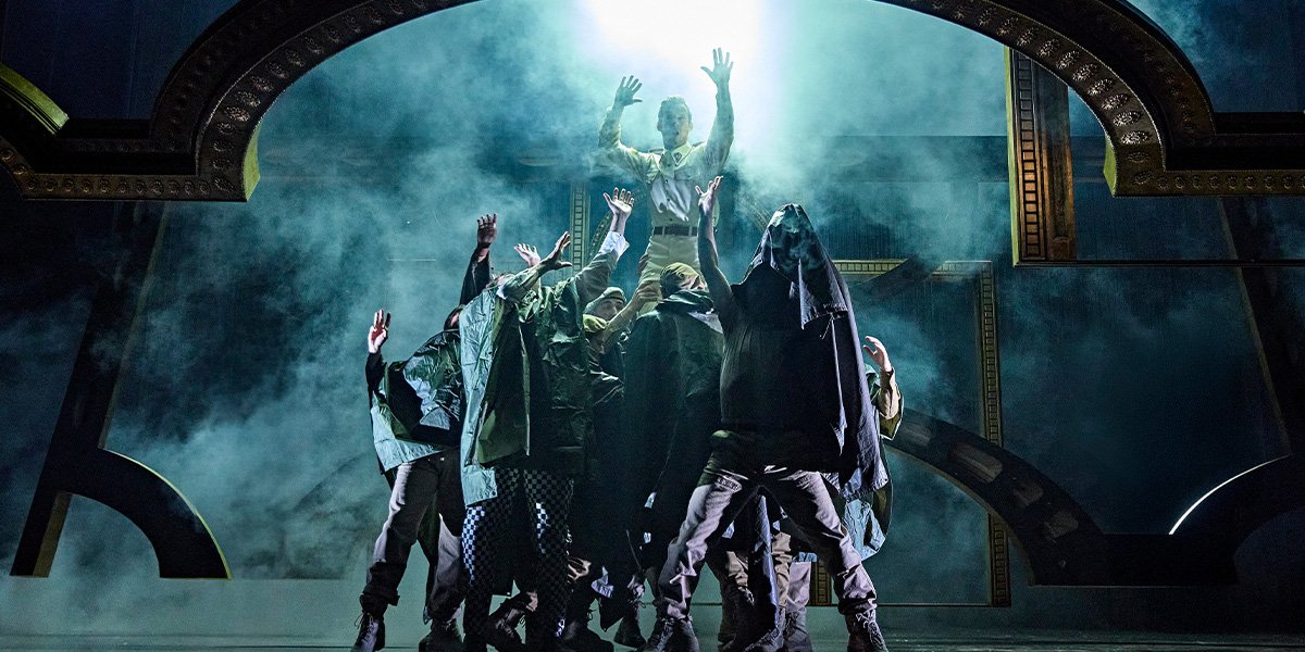 A dramatic scene from Othello, featuring actors in period costumes on a dimly lit stage.