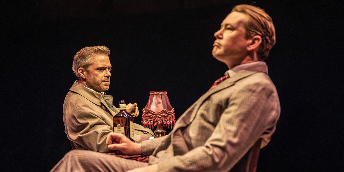 Rory Keenan and Mat Betteridge perform on stage in a dramatic scene from The Spy Who Came in From the Cold.