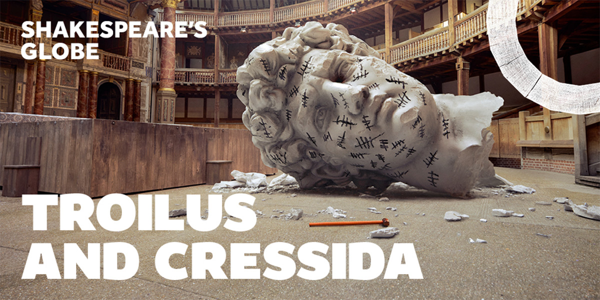 On the right is an image of a large head of a stone statue which has fallen to the ground. On the left it reads 'Troilus And Cressida'