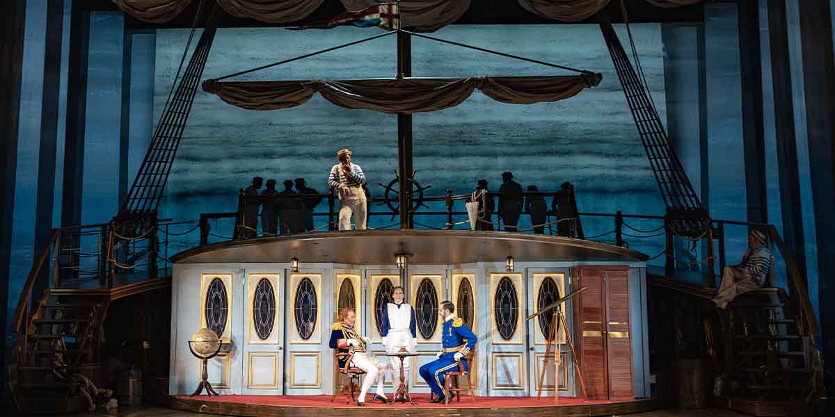 Marcus Farnsworth, Neal Davies, Mel Giedroyc, and John Savournin perform on a ship-themed stage.