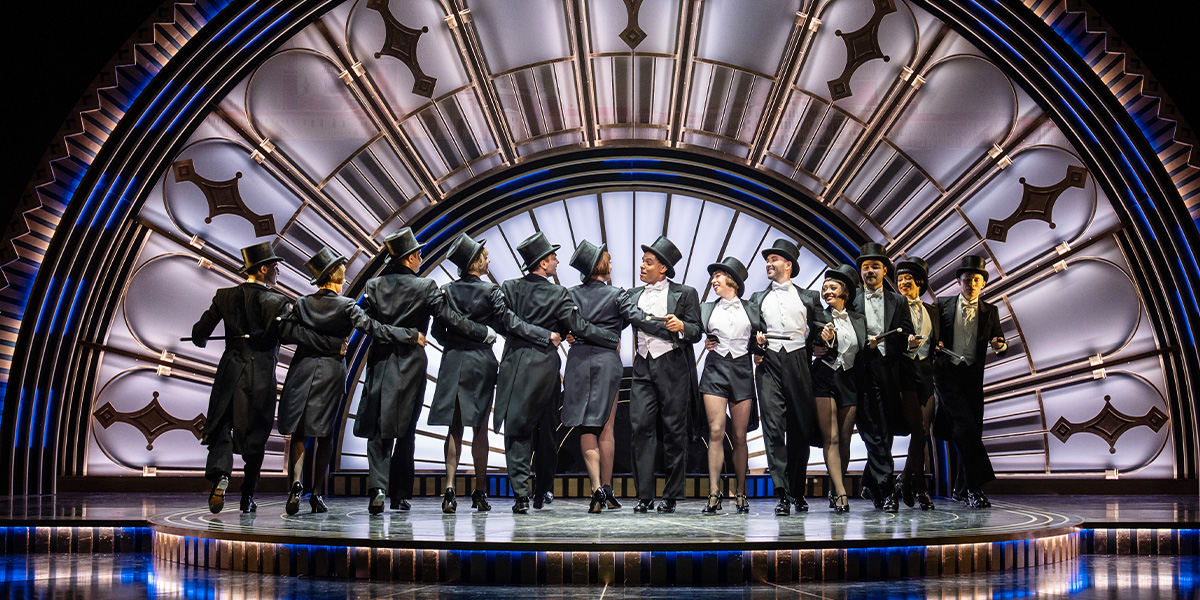 A group of people dance together on stage.