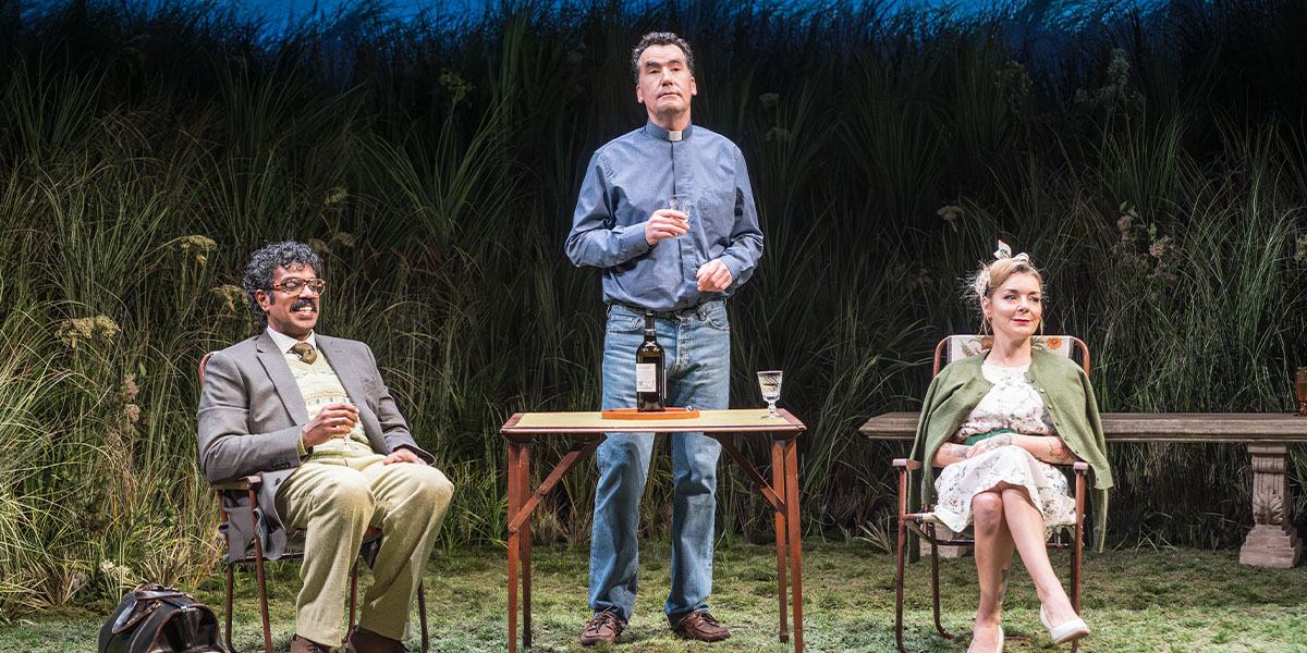 Romesh Ranganathan as Bill, Tim McMullan as Gerald, and Sheridan Smith as Susan, in a theatrical scene.