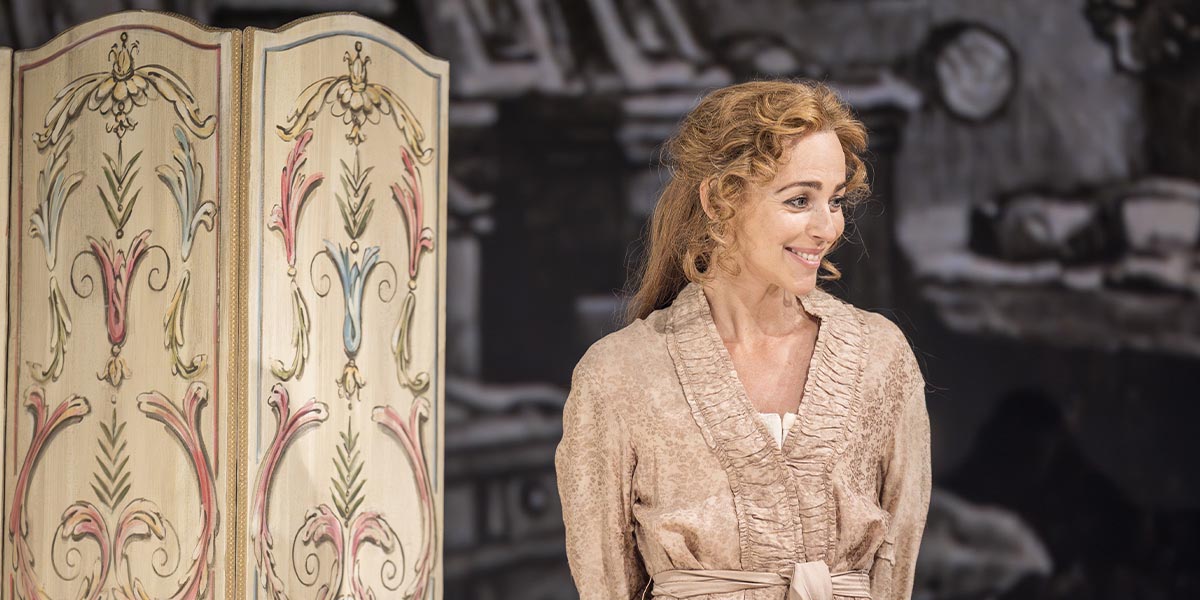 Miranda Raison and Ellen Terry pose together, smiling, in a softly lit setting with neutral tones.