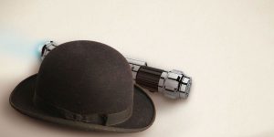 Two pints of Guinness on a wooden table, with a blurred theatre backdrop and warm lighting.
