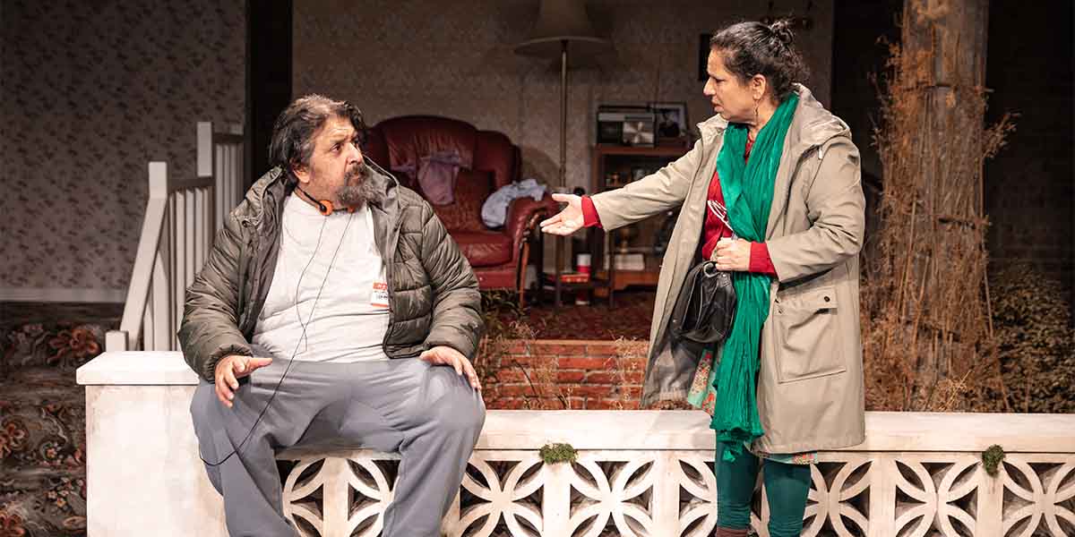 Rehan Sheikh as Liaquat sits on a bench, while Shobu Kapoor as Hema gestures towards him.