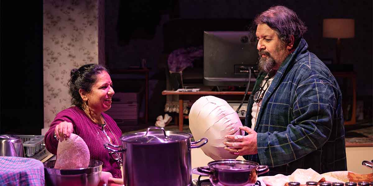Shobu Kapoor as Hema and Rehan Sheikh as Liaquat interact in a kitchen setting, surrounded by cooking utensils.