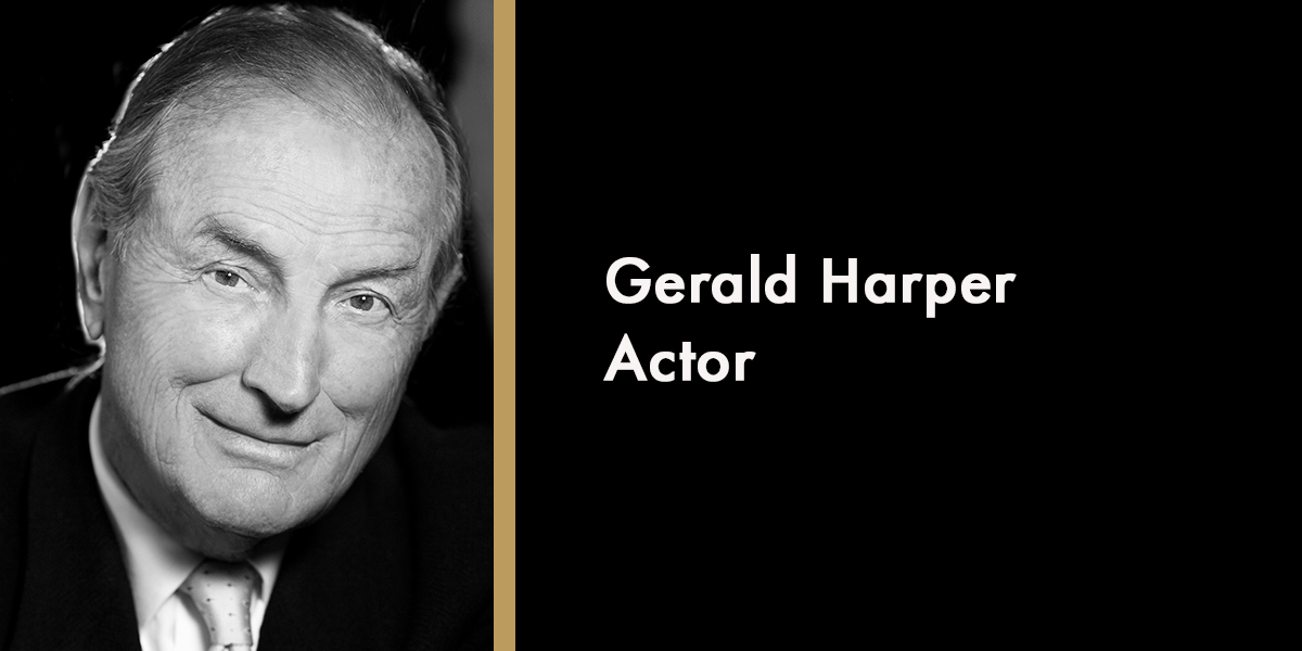 A portrait of Harper Gerald, smiling, wearing a dark suit, with a soft-focus background.