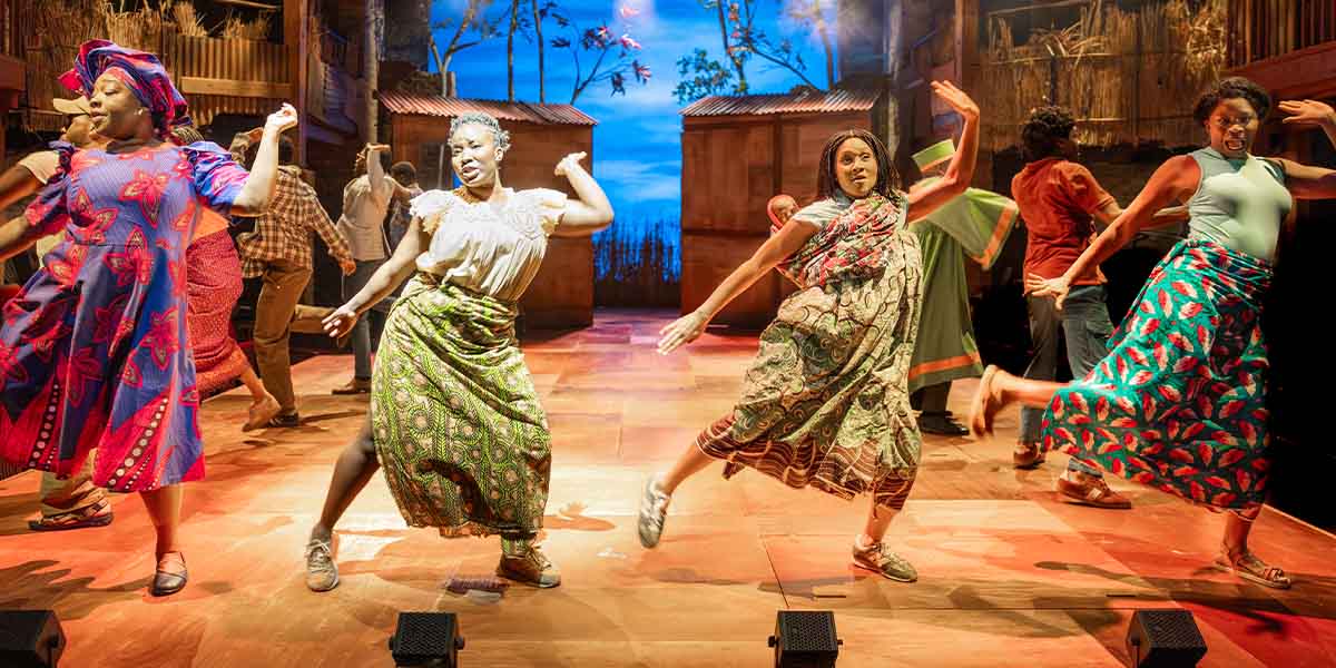 A scene from "The Boy Who Harnessed the Wind" featuring two people dancing in green dresses.