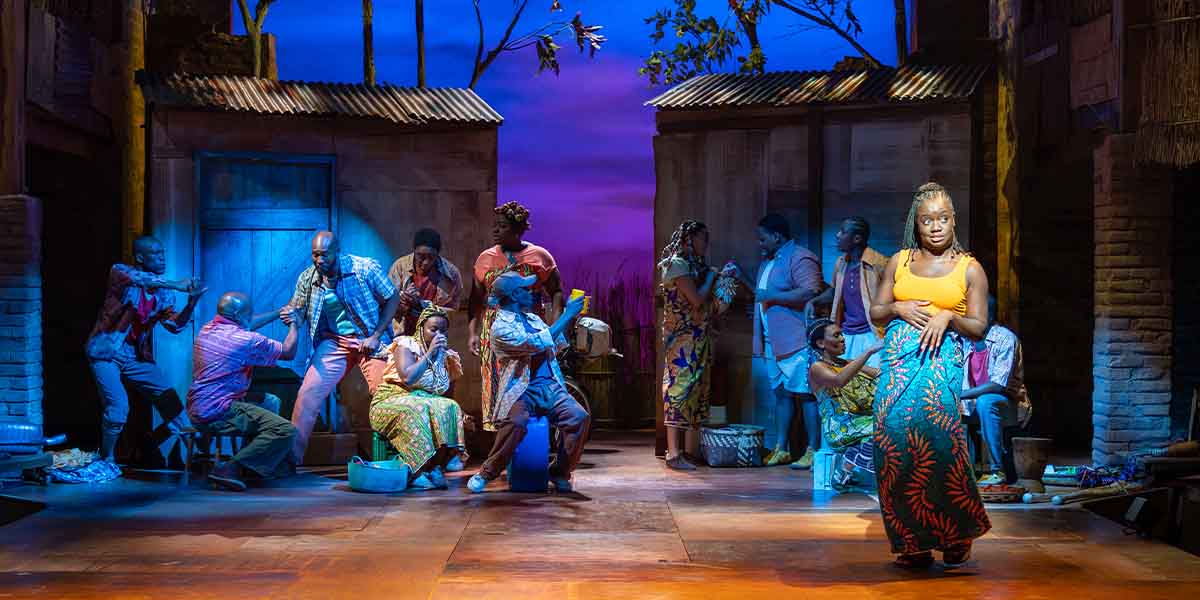 A vibrant stage scene from "The Boy Who Harnessed the Wind," featuring performers in colourful costumes.