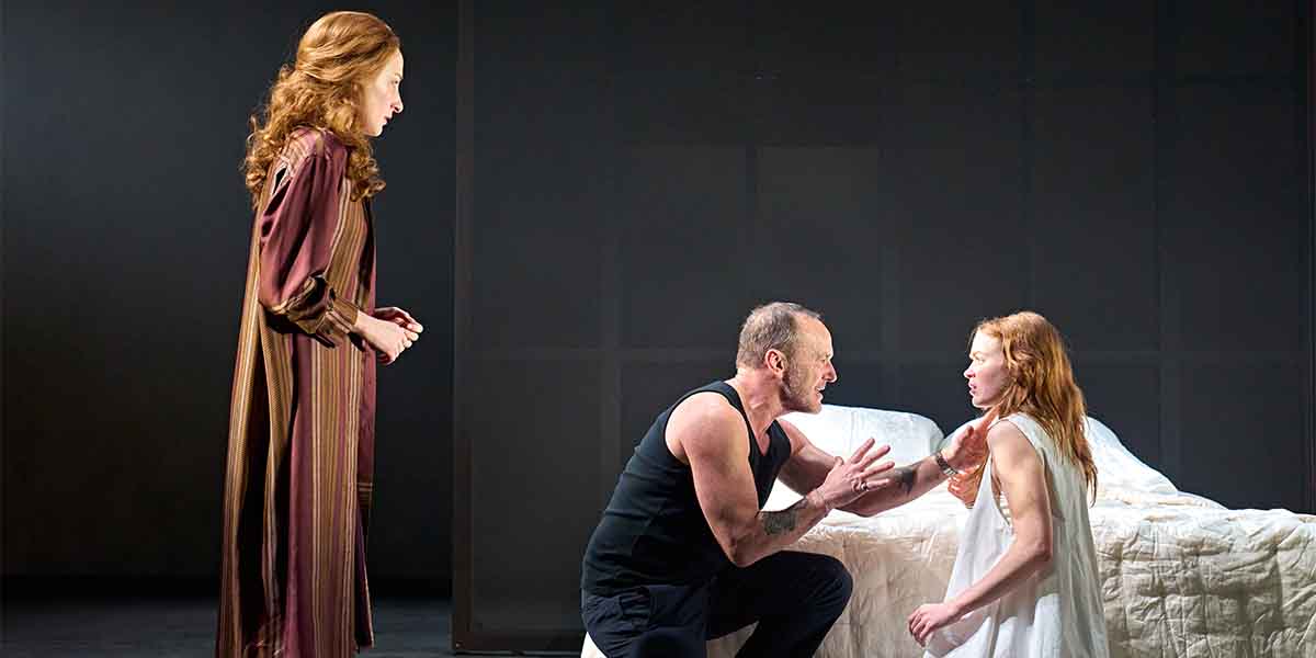 Eden Epstein, Clark Gregg, and Sadie Sink perform a dramatic scene on stage, with a bed in the background.