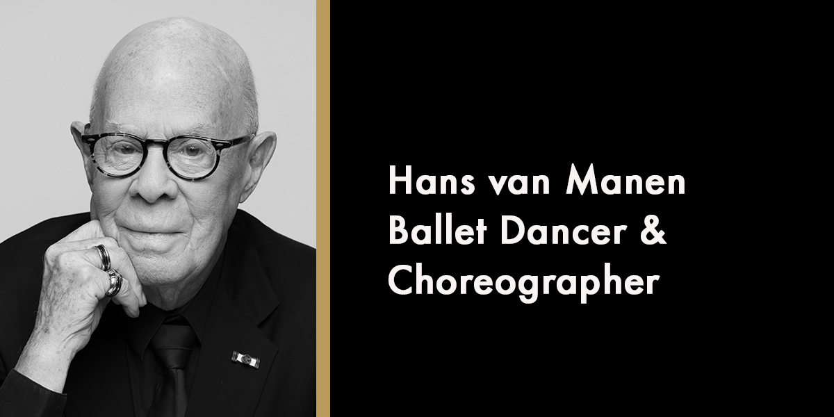A portrait of Hans van Manen, smiling, with a neutral background and soft lighting.