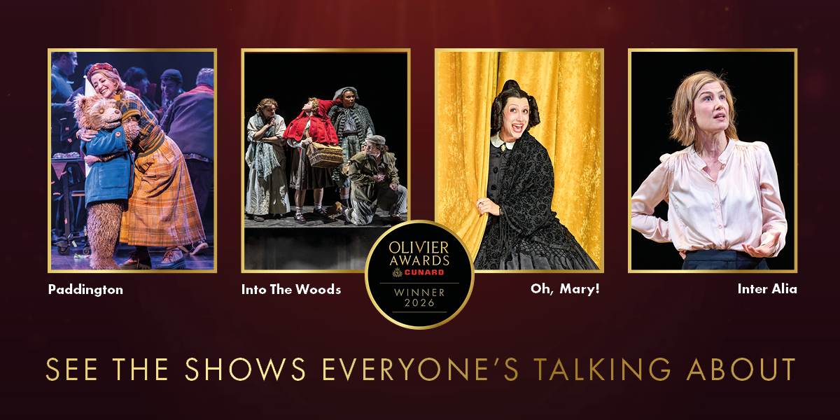 A group of diverse theatre performers celebrates on stage, holding awards and smiling under bright lights.