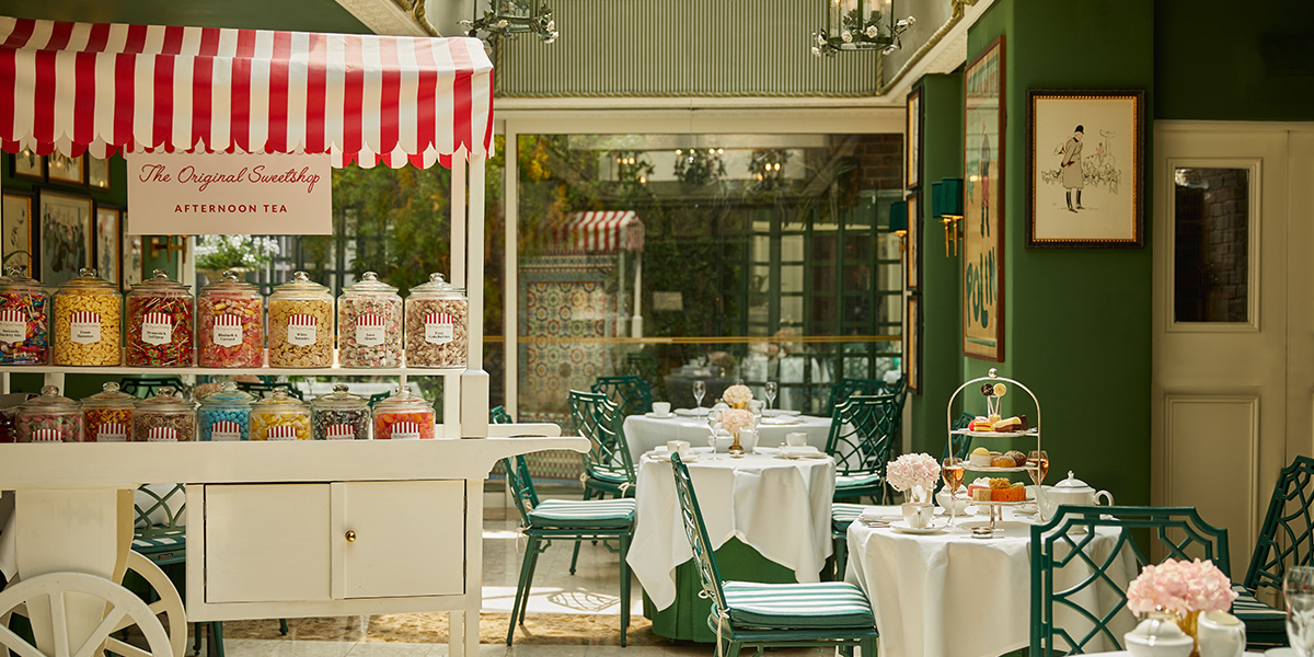 A beautifully arranged afternoon tea featuring assorted pastries and sweets on a decorative table setting.