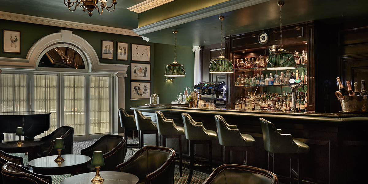 A group of people raises glasses in celebration, surrounded by elegant decor and soft lighting.