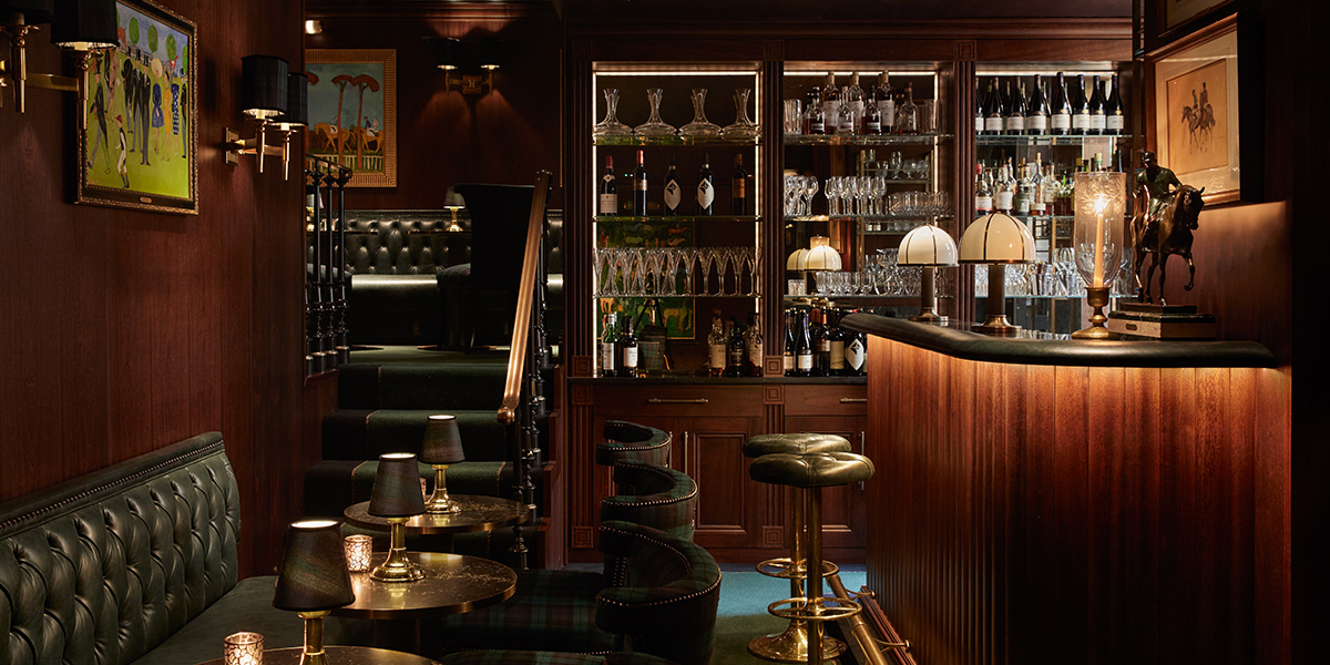 A vibrant bar scene with patrons enjoying drinks, surrounded by rustic wooden decor and warm lighting.