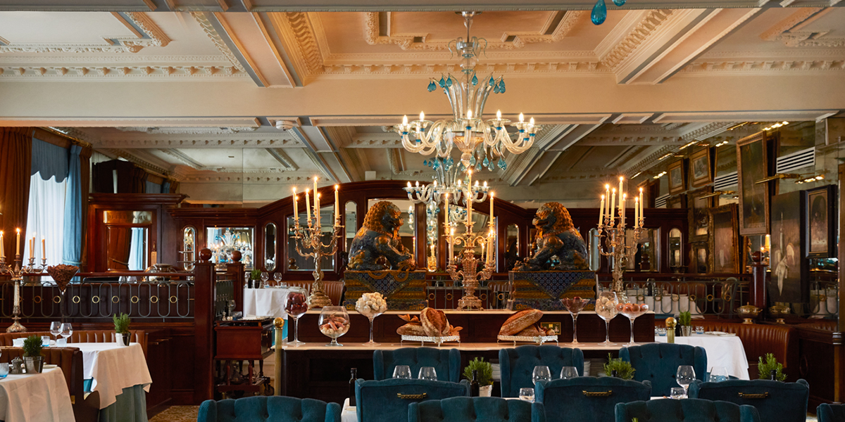 A beautifully arranged table setting featuring elegant glassware and fine dining dishes in a luxurious restaurant.