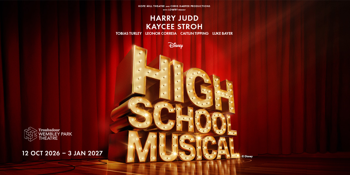 A vibrant scene from High School Musical featuring students in colourful costumes performing on stage.